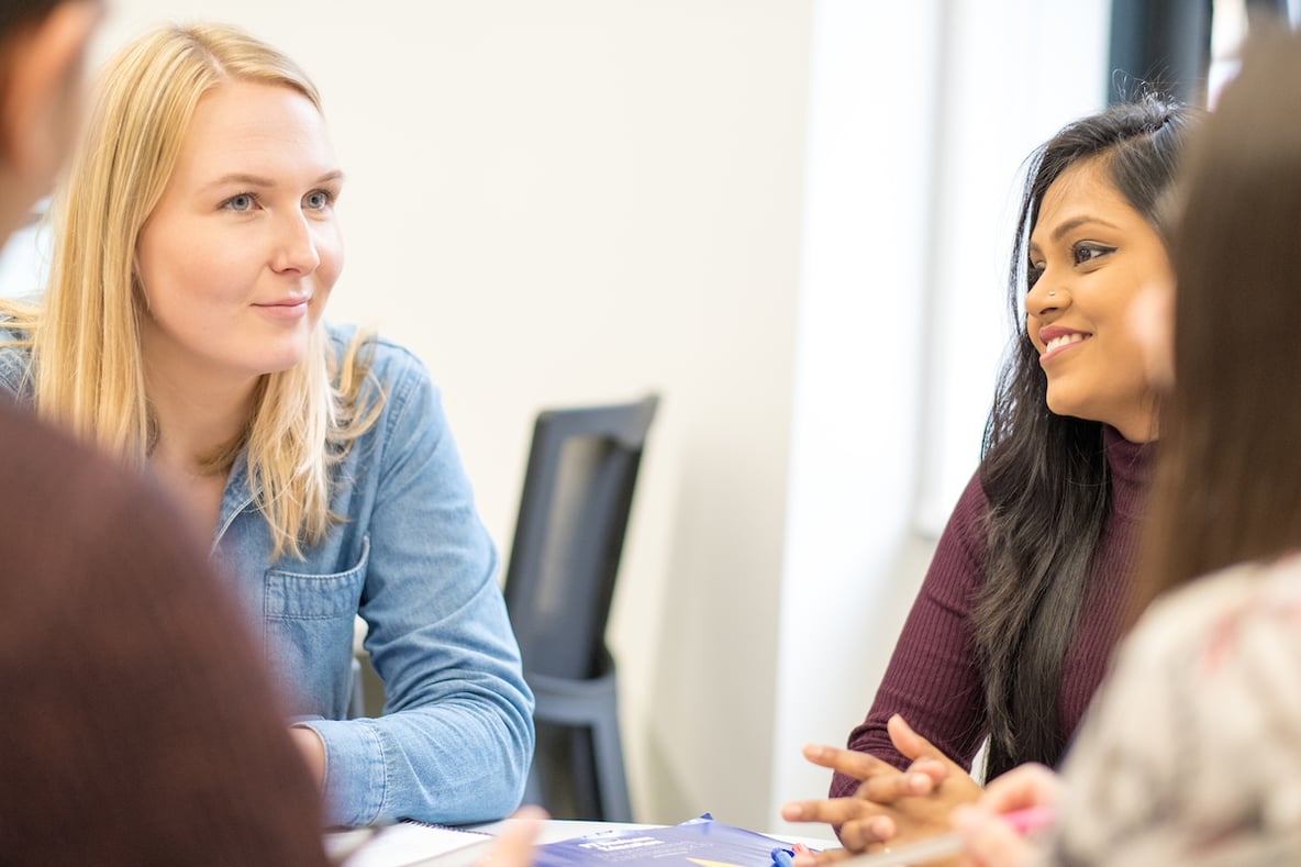 female students on campus talking together